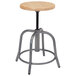 A National Public Seating lab stool with a wooden seat and metal legs.