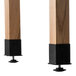 A pair of wooden legs with black rubber feet on a National Public Seating science lab table.