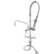 A T&S low profile deck mounted pre-rinse faucet with a hose.