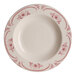An ivory china pasta bowl with red flowers on it.