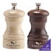 A Chef Specialties walnut pepper mill and natural maple salt mill set on a counter.