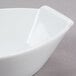 A CAC Super White porcelain boat bowl on a gray surface.