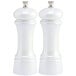 Two white salt and pepper mills with black knobs.