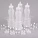A group of clear polycarbonate bottles with white lids on a white tray.