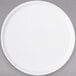 A Carlisle white melamine plate with a round rim.