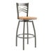 A Lancaster Table & Seating metal bar stool with a cherry wood seat.