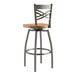 A Lancaster Table & Seating metal cross back bar stool with a cherry wood seat.