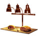 A Hanson Heat Lamps carving station with meat on a cutting board under the heat lamps.