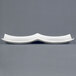 A white rectangular divided tasting plate with a curved edge.