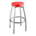 A Lancaster Table & Seating red swivel bar stool with metal legs.