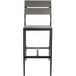 A BFM Seating black aluminum outdoor bar stool with gray synthetic teak back and seat.