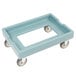 A slate blue plastic Cambro pizza dough box dolly with black wheels.