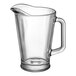 A clear glass pitcher with a handle.