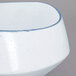 A white porcelain bowl with a blue rim.