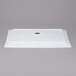 A blue speckled rectangular porcelain platter with a white logo on it.