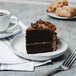 A 10 Strawberry Street Arctic Blue porcelain plate with a slice of chocolate cake and a cup of coffee.