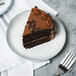 A slice of chocolate cake on a 10 Strawberry Street Arctic Blue porcelain plate with a fork.