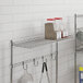 A Regency chrome wire cantilever shelf holding spices and containers.