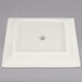 A white square Homer Laughlin china plate with a logo in the middle.