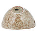 A white porcelain bowl with brown speckles and cut-out handles.