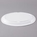 a white plate on a gray surface