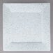 A white square plate with blue speckled spots.