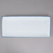 A white rectangular porcelain platter with blue speckles.