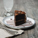 A slice of chocolate cake on a 10 Strawberry Street Arctic Blue porcelain salad plate with a fork.