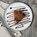 A 10 Strawberry Street Arctic Blue porcelain salad plate with a slice of chocolate cake on it.