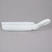 A white porcelain casserole bowl with a handle.