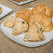 A rectangular porcelain platter with a plate of pastries with cranberry and orange.