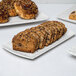 A rectangular blue speckled porcelain platter with a stack of cookies on it.