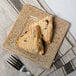 A 10 Strawberry Street Tiger Eye porcelain bread and butter plate with two scones on it.