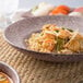 A 10 Strawberry Street Biseki Himalayan salt stoneware bowl filled with pasta on a table.