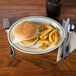 An ivory oval china platter with a burger, lettuce, and tomato.