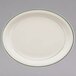 A white oval china platter with a green band on the rim.
