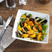 A bowl of salad with Del Monte Mandarin Oranges and vegetables on a plate.