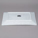 A white rectangular porcelain platter with black speckles.