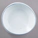 A white porcelain pasta bowl with a blue rim.