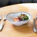 A bowl of salad on a table.