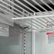A white shelf in a Beverage-Air Elite Series refrigerated sandwich prep table with white labels.