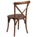 A Flash Furniture pecan wooden stackable cross back chair with a cushion.