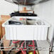 A white Metro tote box on a shelf.