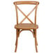 A Flash Furniture oak wood stackable cross back chair.