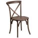 A Flash Furniture Hercules Early American wood banquet chair with a cross back.