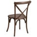 A Flash Furniture wooden stackable banquet chair with a cross back and cushion.