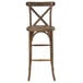 A Flash Furniture Hercules Dark Antique Wood Stackable Cross Back Barstool on a table in a bar.