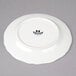 A white Tuxton Charleston bread and butter plate with a black logo.