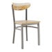 A Lancaster Table & Seating Boomerang chair with a wooden seat and back on a metal frame.