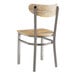 A Lancaster Table & Seating Boomerang chair with a driftwood seat and back on a metal frame.